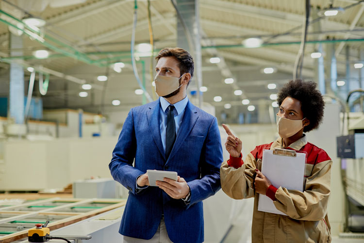 two employees doing quality check in a manufacturing unit 